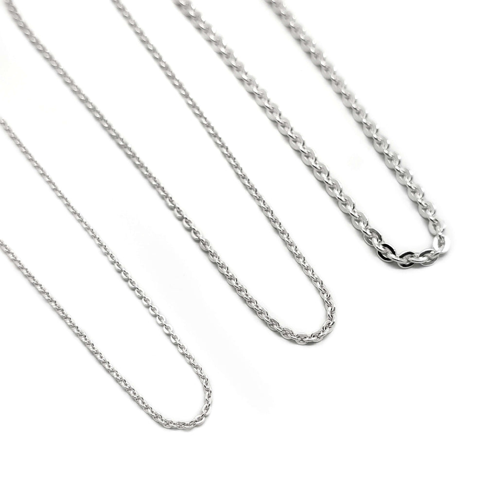 Three sterling silver flat cable link chains in varying thicknesses on a white background