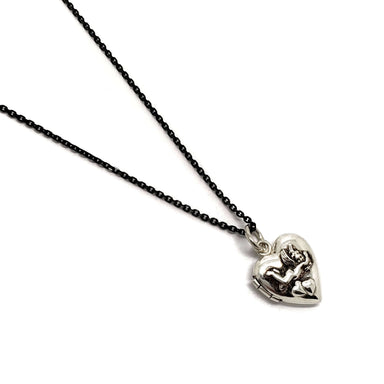 Sterling silver heart-shaped locket with cherub relief on black chain, front view
