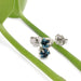 Swiss blue topaz six-prong stud earrings in white gold resting on green stems