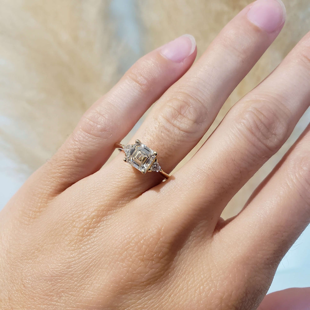 Asscher cut lab diamond engagement ring in yellow gold shown on hand