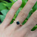 Teal Australian sapphire and diamond yellow gold ring shown on hand
