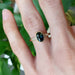 Teal Australian sapphire and diamond yellow gold ring worn on hand