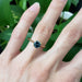 Teal Australian sapphire engagement ring in yellow gold worn on hand