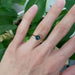 Teal Australian sapphire ring in yellow gold stacked with diamond band on hand