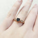 Teal Montana sapphire and diamond engagement ring in rose gold shown on hand