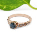 Teal Montana sapphire and diamond engagement ring in rose gold with leaf details, side view