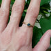 Teal Montana sapphire engagement ring in yellow gold, worn on hand