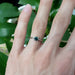 Teal sapphire and diamond white gold ring shown on hand