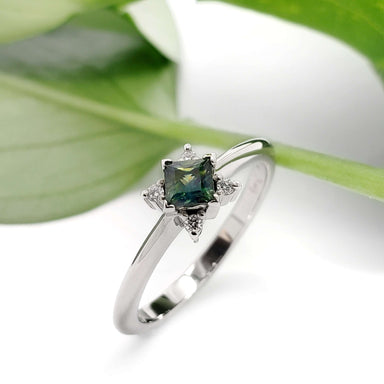 Teal sapphire and lab diamond engagement ring in white gold with leaf background