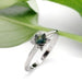 Teal sapphire and lab diamond engagement ring in white gold with leaf background