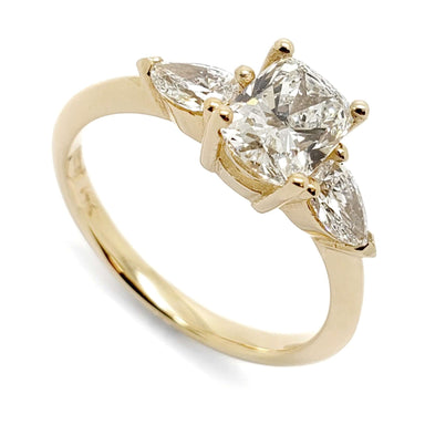 Three-stone engagement ring in 14kt yellow gold with cushion cut and pear lab diamonds