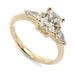 Three-stone engagement ring in 14kt yellow gold with cushion cut and pear lab diamonds