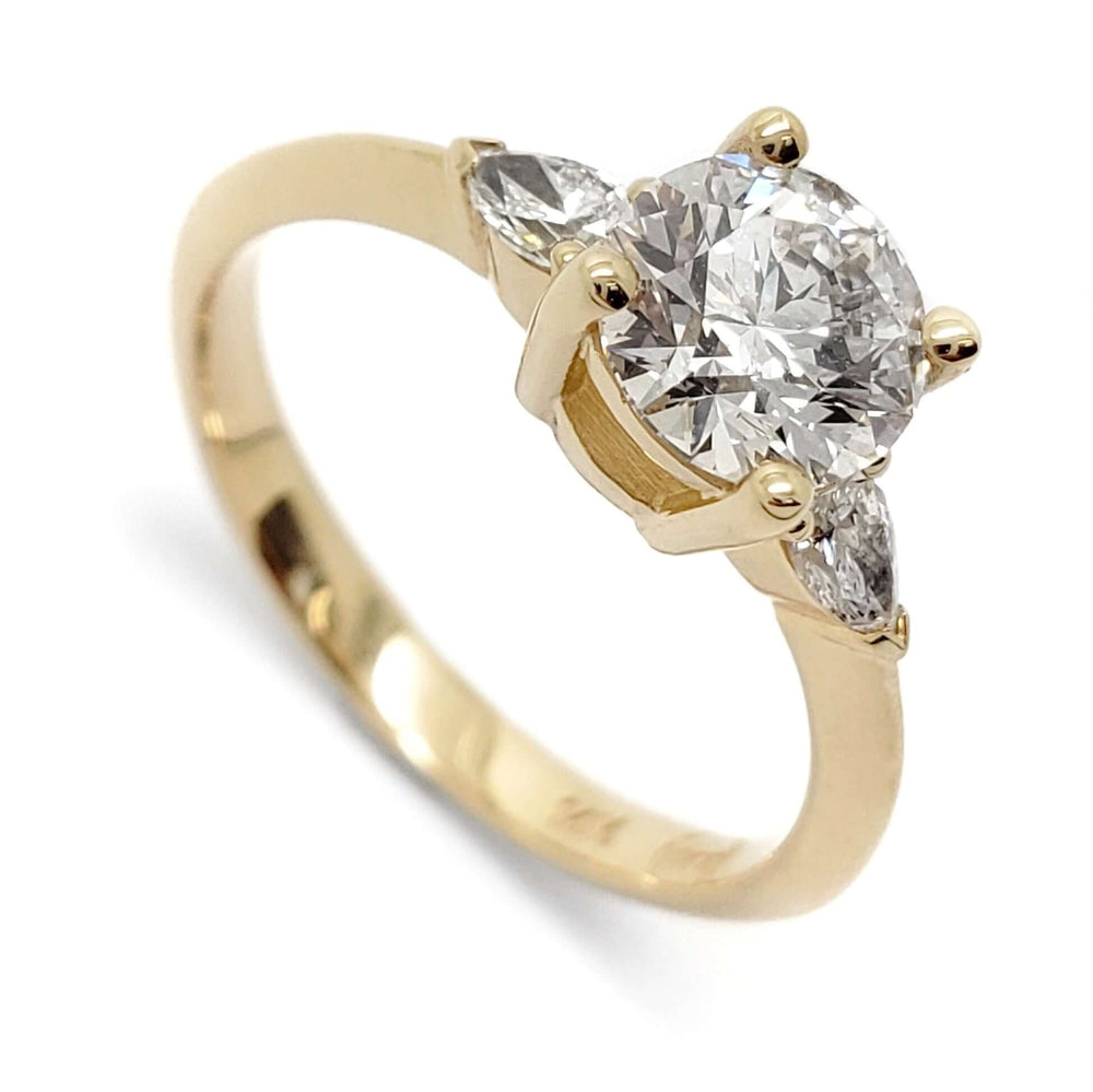Three-stone engagement ring in 14kt yellow gold with round lab diamond and pear-shaped side diamonds