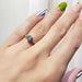 Three-stone vintage diamond ring in yellow and white gold shown on hand
