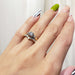 Three-stone vintage diamond ring paired with pave wedding band, both worn on hand