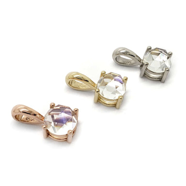 Three rose cut moonstone pendants in 14kt yellow, rose, and white gold on white background