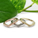 Three chevron wedding rings in 14kt rose, white, and yellow gold with saw blade texture