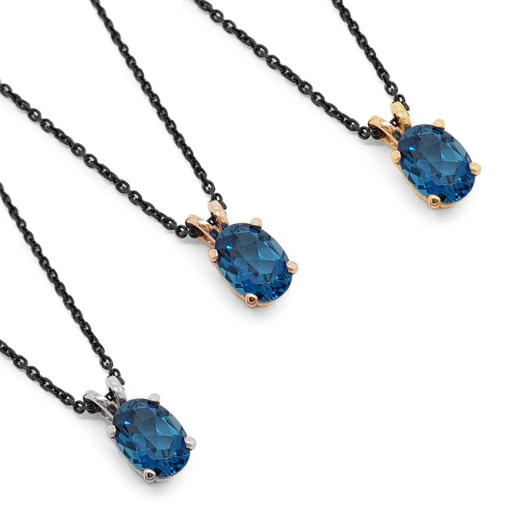 Three oval London topaz pendants in 14kt rose, yellow, and white gold on black chains