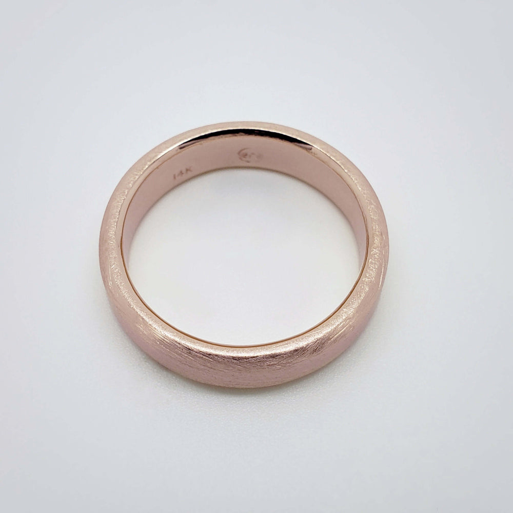 Top view of 14k rose gold flat wedding ring with brushed finish
