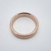 Top view of 14k rose gold flat wedding ring with brushed finish