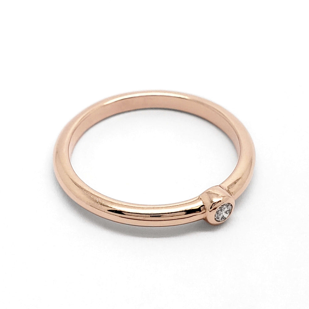 Minimalist 14kt rose gold bezel set diamond ring viewed from above