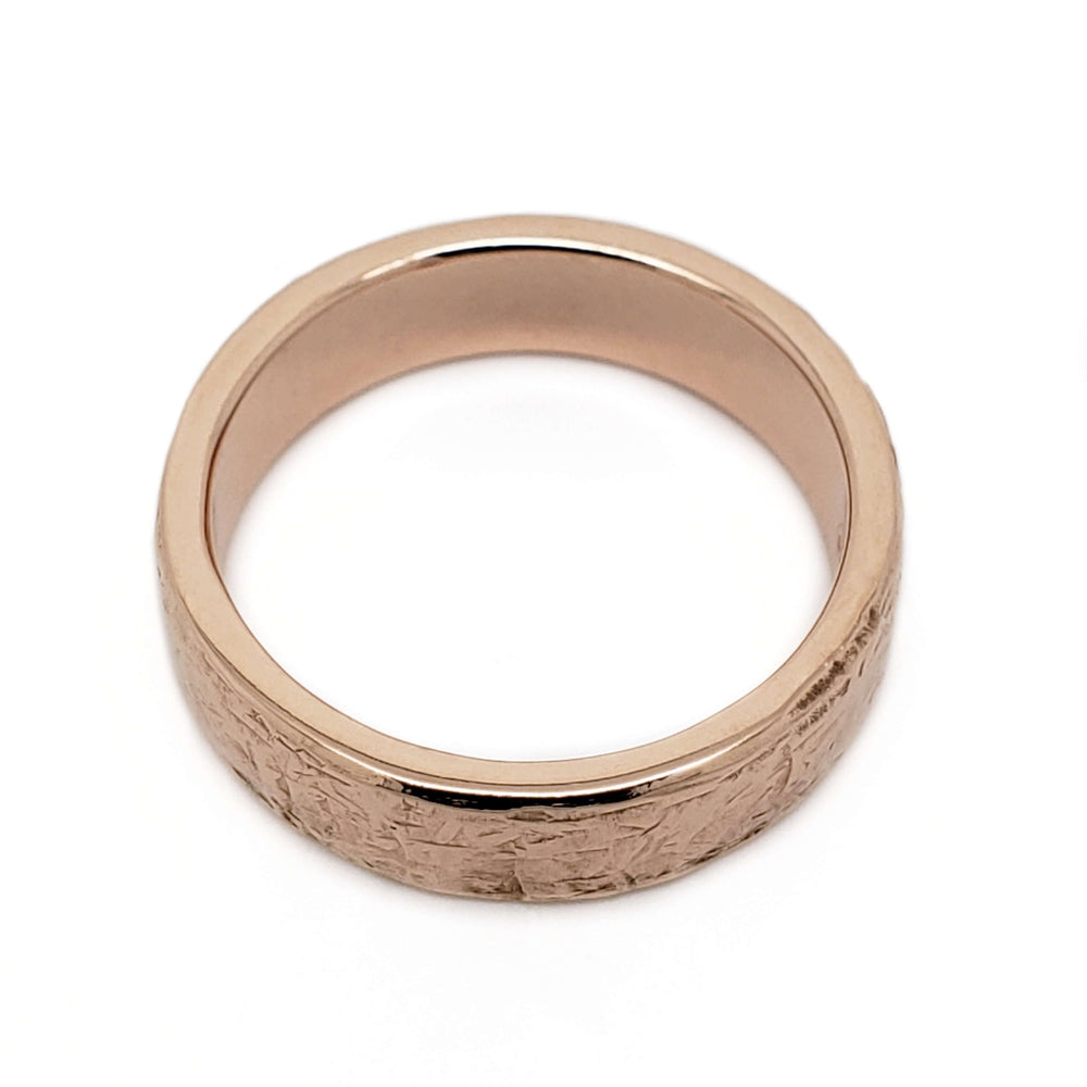 Flat profile 14kt rose gold wedding ring with elephant skin texture, top view