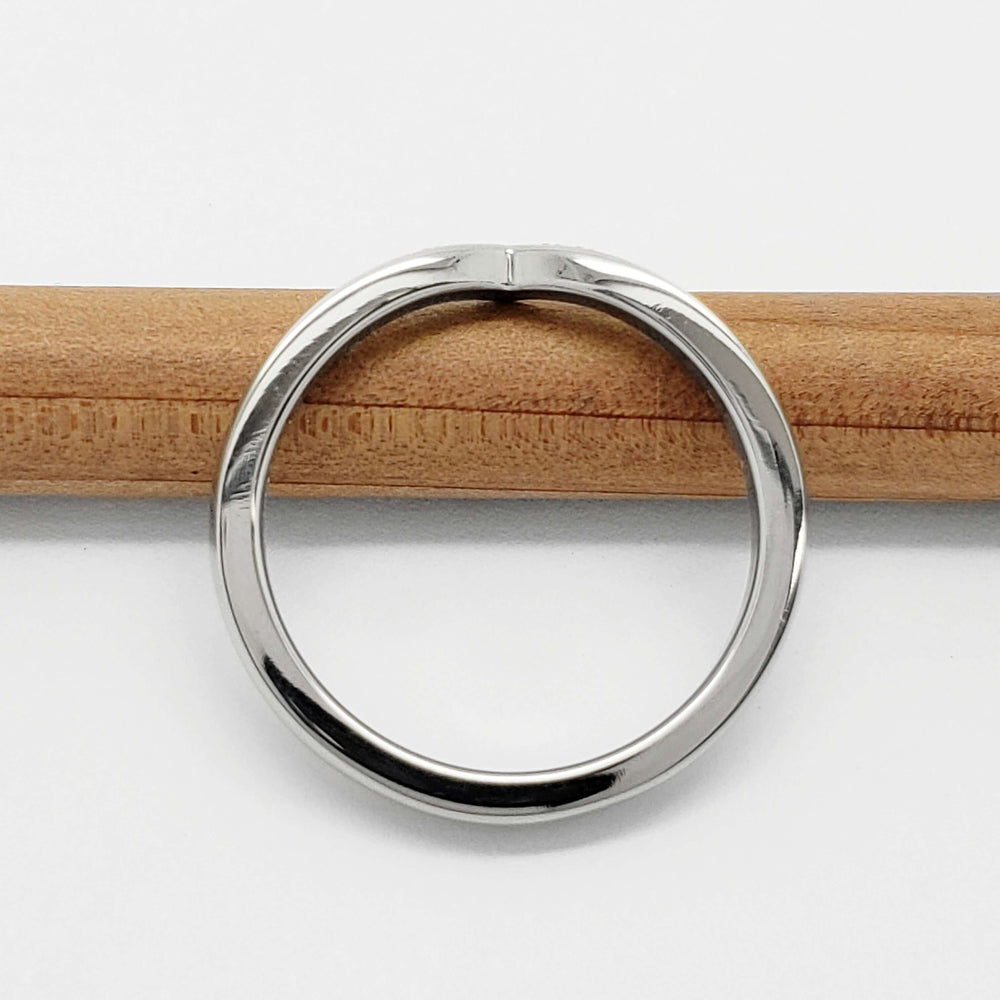 Top view of 14kt white gold chevron wedding band on pencil, showing smooth band