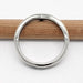 Top view of 14kt white gold chevron wedding ring with millgrain detail, resting on pencil