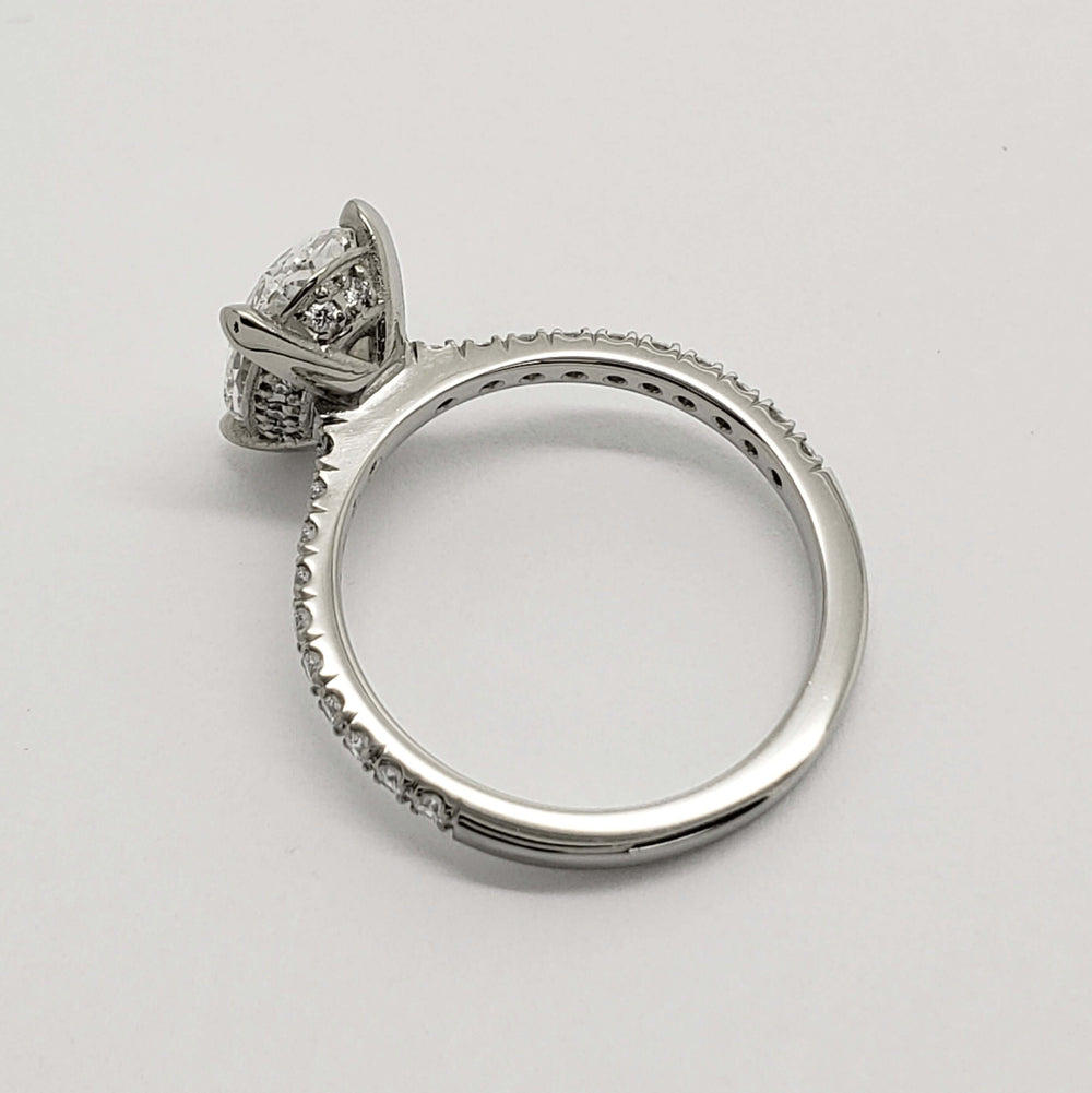 Top view of 14kt white gold oval lab diamond ring with French pave band