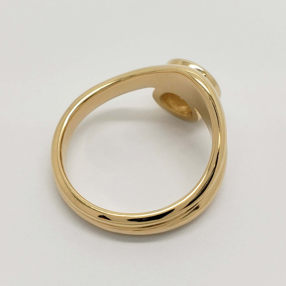 Top view of 14kt yellow gold curvy engagement ring showing asymmetrical band