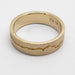 Top view of 14kt yellow gold wedding ring with engraved mountain range pattern