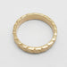 Top view of 14kt yellow gold wedding ring with hand engraved leaf pattern