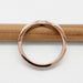 Top view of a rose gold chevron wedding ring showing the band profile