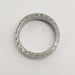 Top view of engraved 14kt white gold wedding ring with millgrain detail