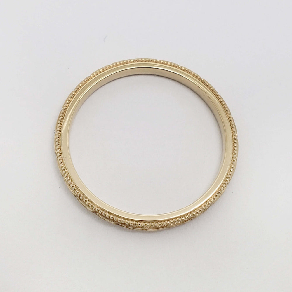 Top view of handcrafted 14kt yellow gold wedding ring with engraved wheat design