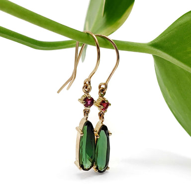 Handcrafted 14kt yellow gold earrings with green tourmaline and red spinel on a plant stem