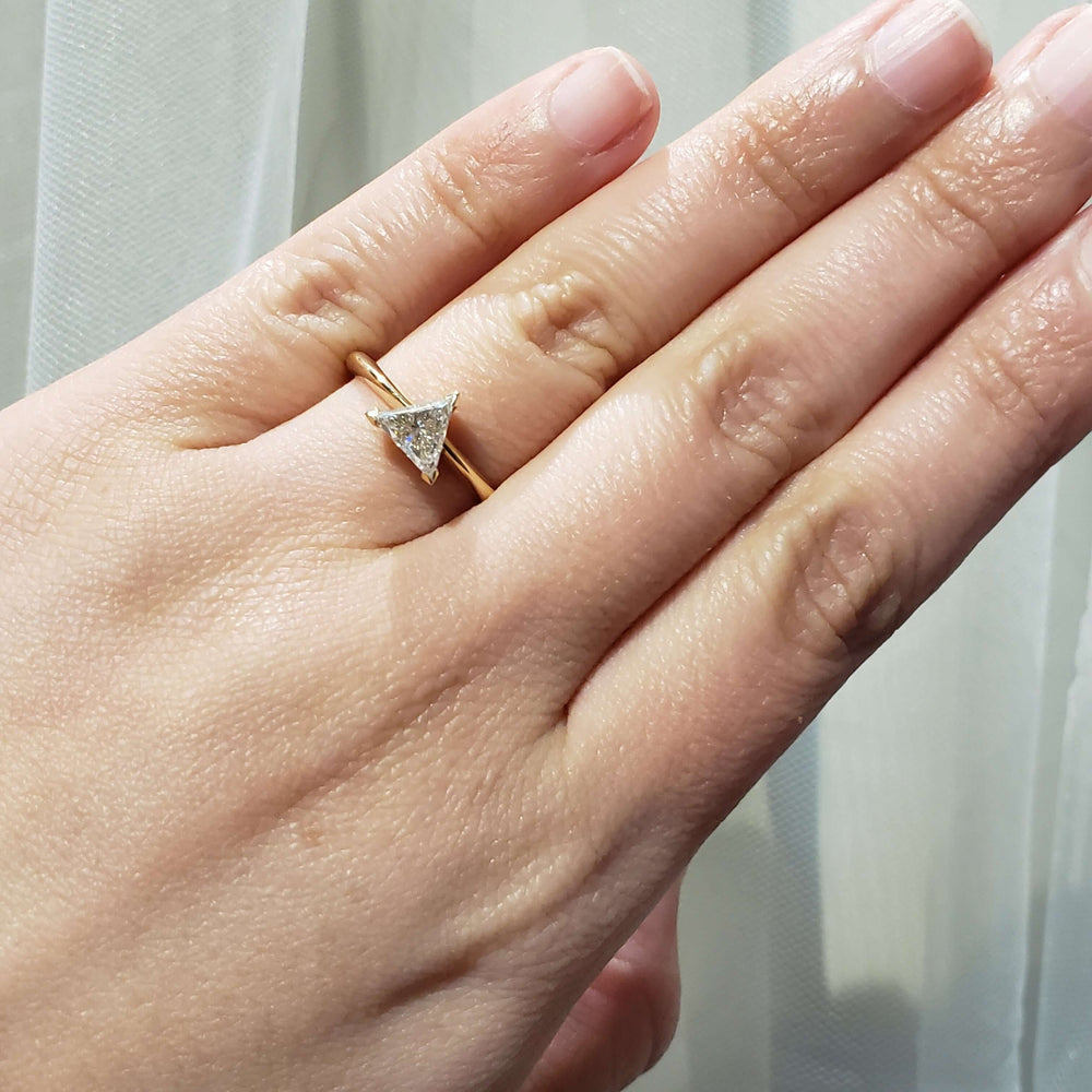 Triangle cut lab-grown diamond ring in yellow gold shown on a hand