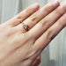 Triangle cut lab-grown diamond ring in yellow gold shown on a hand