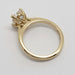 Tulip-style setting of 14kt yellow gold engagement ring with hidden lab diamonds under the centre stone