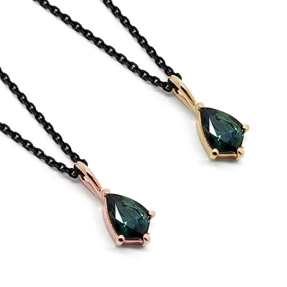 Two shield-cut green sapphire pendants in 14kt yellow and rose gold on black chains