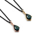 Two shield-cut green sapphire pendants in 14kt yellow and rose gold on black chains