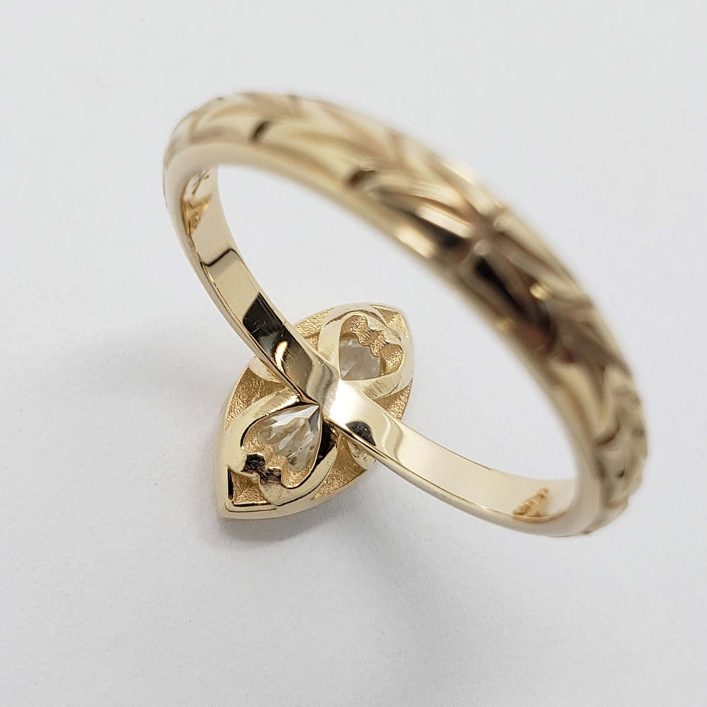 Underside detail of 14kt yellow gold ring with marquise lab diamond and hand-engraved band