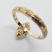 Underside detail of 14kt yellow gold ring with marquise lab diamond and hand-engraved band