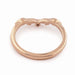 Underside of 14k rose gold leafy wedding ring with bezel-set diamond