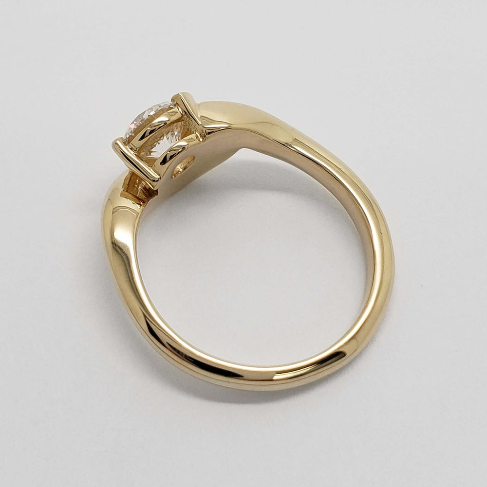 Underside of 14kt yellow gold ring showing diamond setting and shank