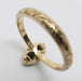 Underside of 14kt yellow gold ring showing marquise green sapphire and engraved detail