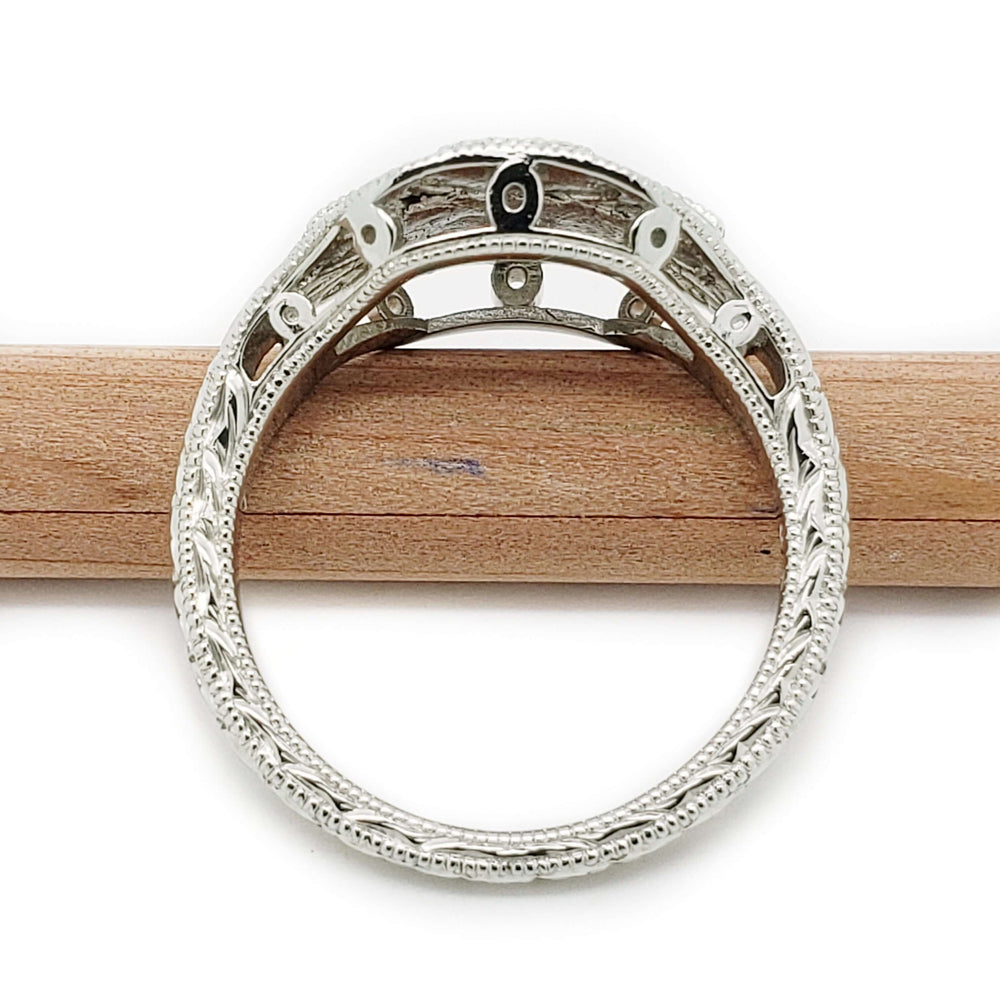 Underside of 19kt white gold Art Deco diamond ring showing filigree and millgrain details