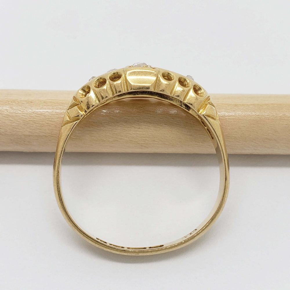 Underside of antique 18kt yellow gold diamond ring showing engraved details