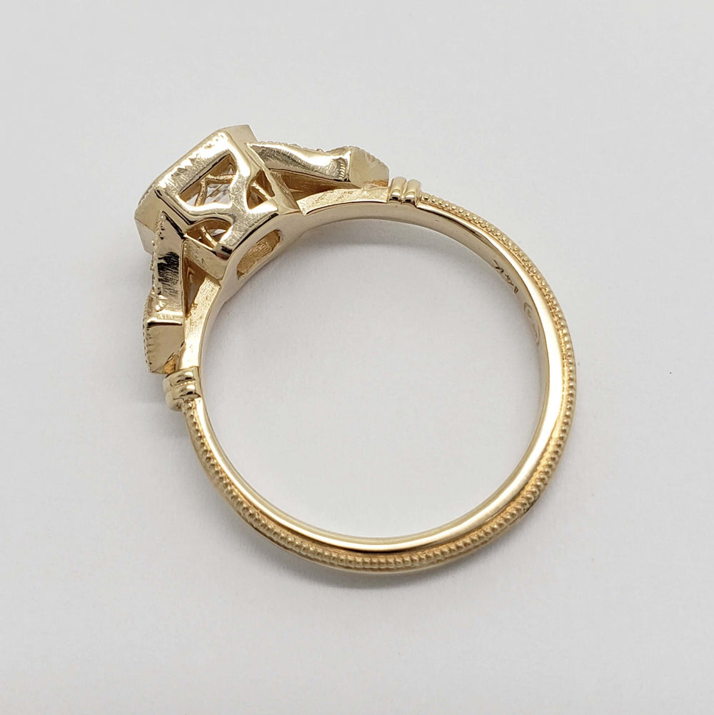 Underside view of 14kt yellow gold engagement ring with openwork setting