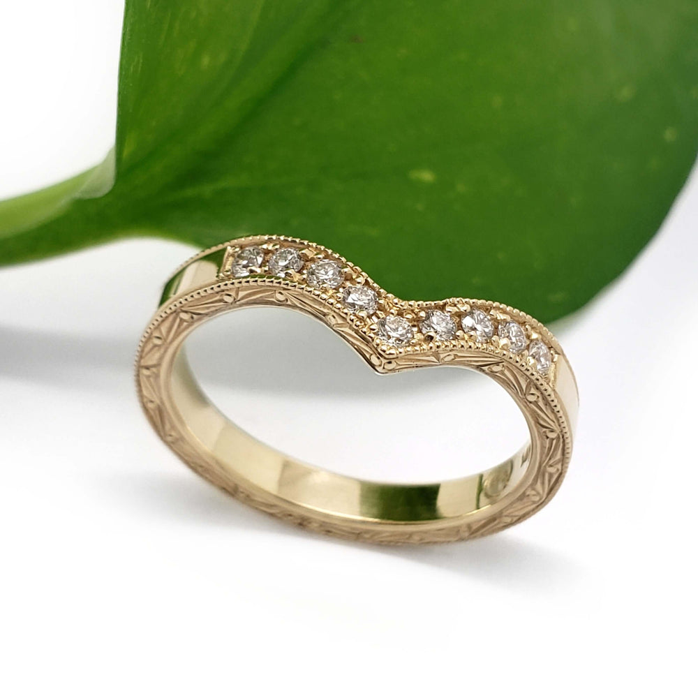 Vintage-inspired yellow gold chevron wedding ring with pave diamonds and hand engraving